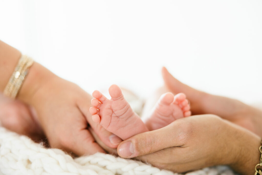 hospital bag checklist for mom and baby - newborn in parents hands Bend Oregon