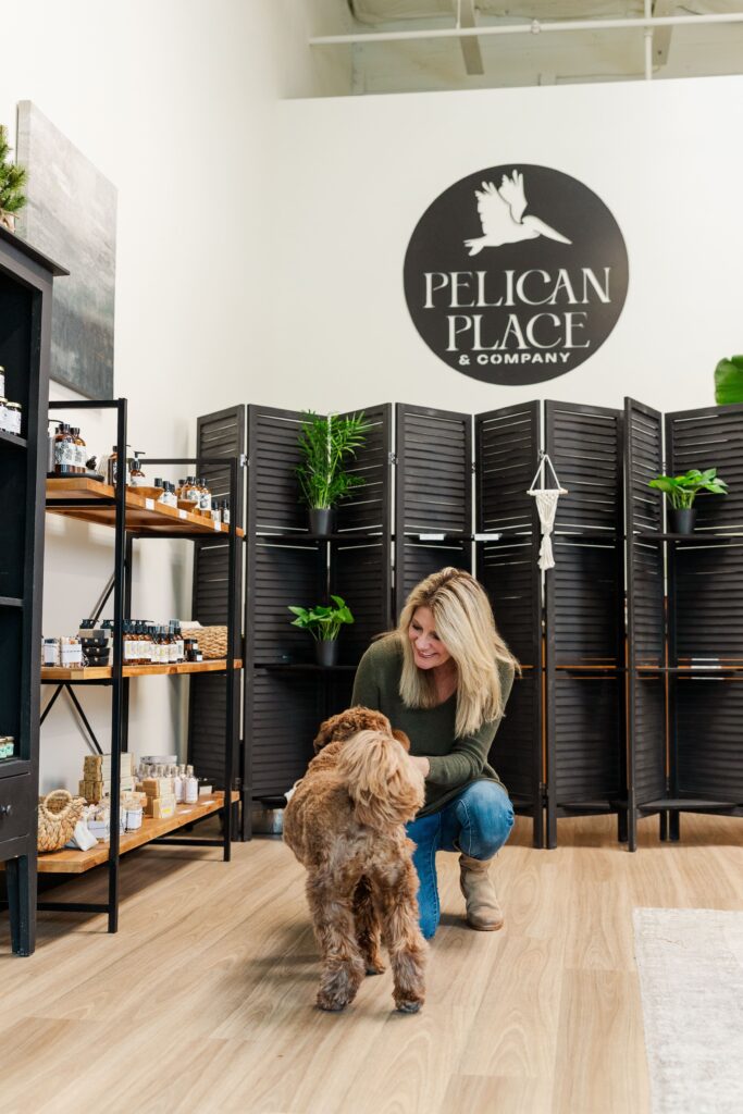 Founder and her dog inside the  shop, with curated products in the background.