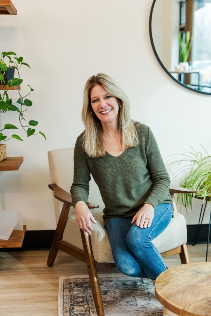 Founder of Pelican Place & Company sitting and posing for a headshot portrait.