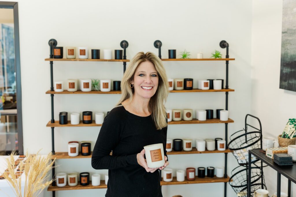 Pelican Place & Company founder holding a candle and posing for headshot.