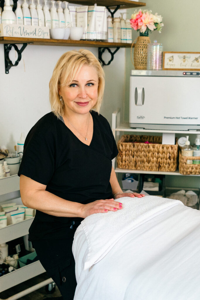 Sage & Honey Spa owner preparing a treatment, smiling during branding shoot