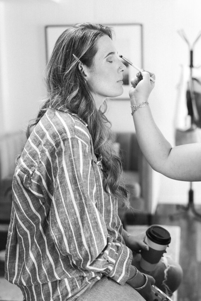 Balck and white Amara getting her hair and makeup done before her session.