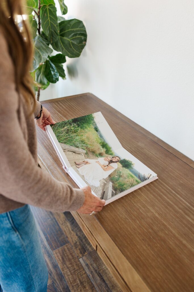 Luxury heirloom book displaying intimate portraits from a studio and outdoor motherhood session
