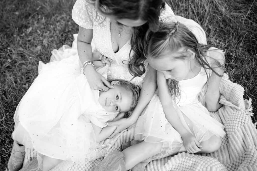 Black and white Amara and her daughters, capturing connection.