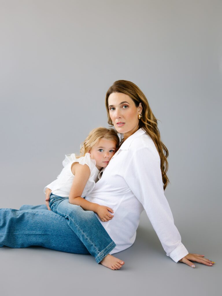 Amara holding her daughter during a  session, intimate and timeless.