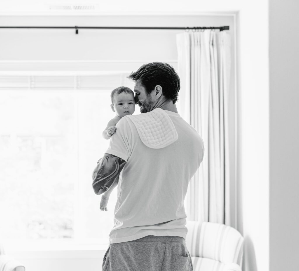 daddy holding his baby in a newborn session