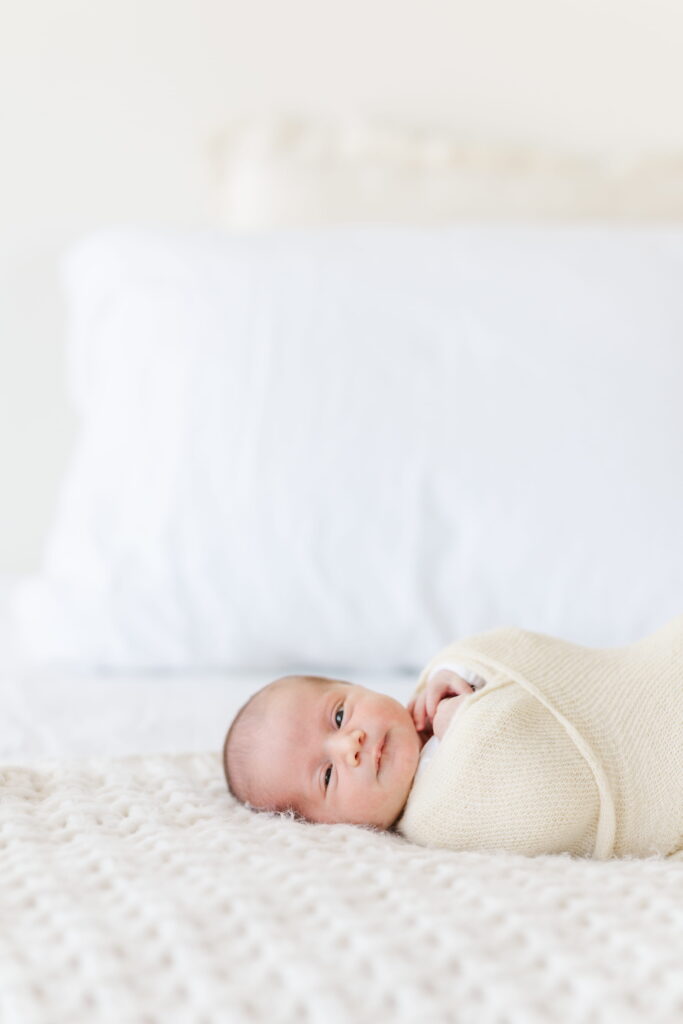 Baby lying down and smiling during a Bend newborn Photography session