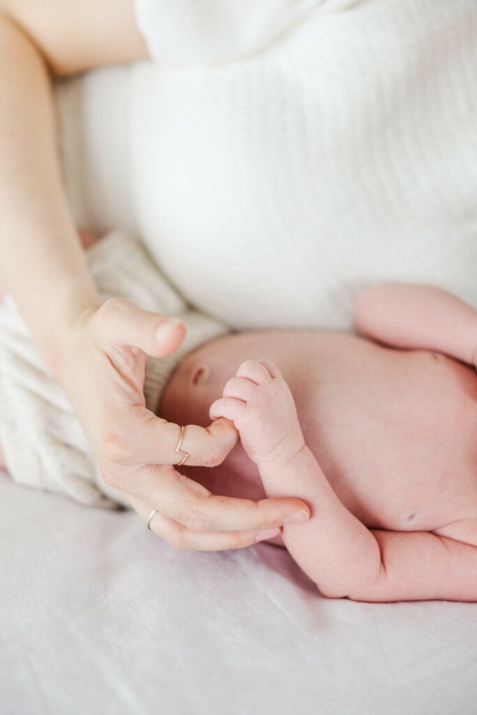 Baby sleeping on bed during studio newborn photography session