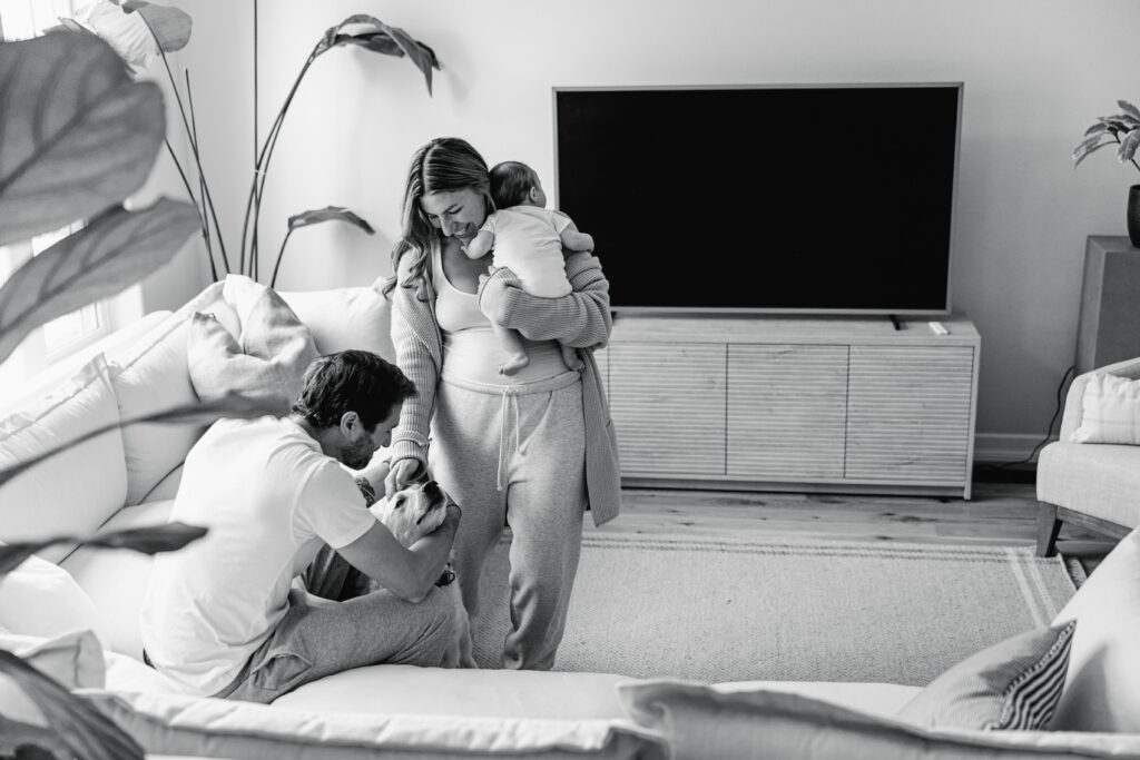 Mom and dad sharing a tender moment with their newborn in their home.