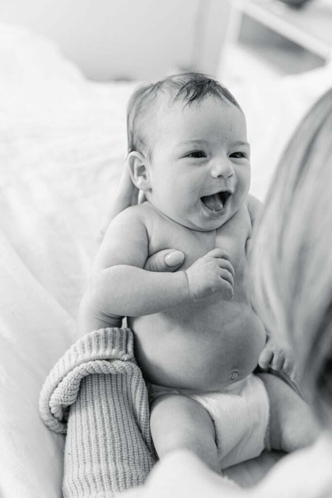 Close‑up of newborn’s face in soft light.