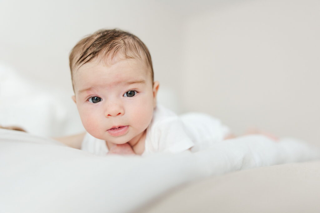 A baby looking at the camera during an in-home session in Bend, Oregon.