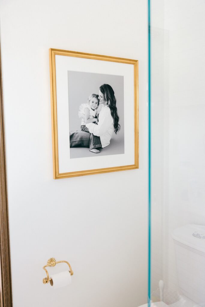 Single black and white mother daughter portrait in gold frame, bathroom wall art